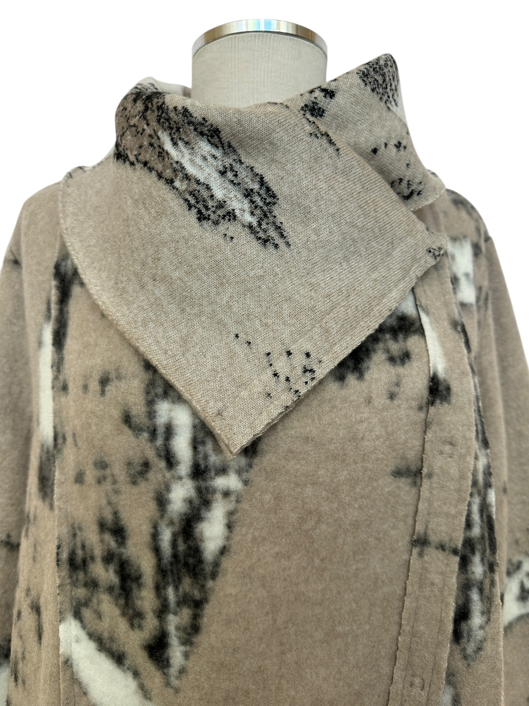 Neckline view of black, beige & white felted snap coat for fall