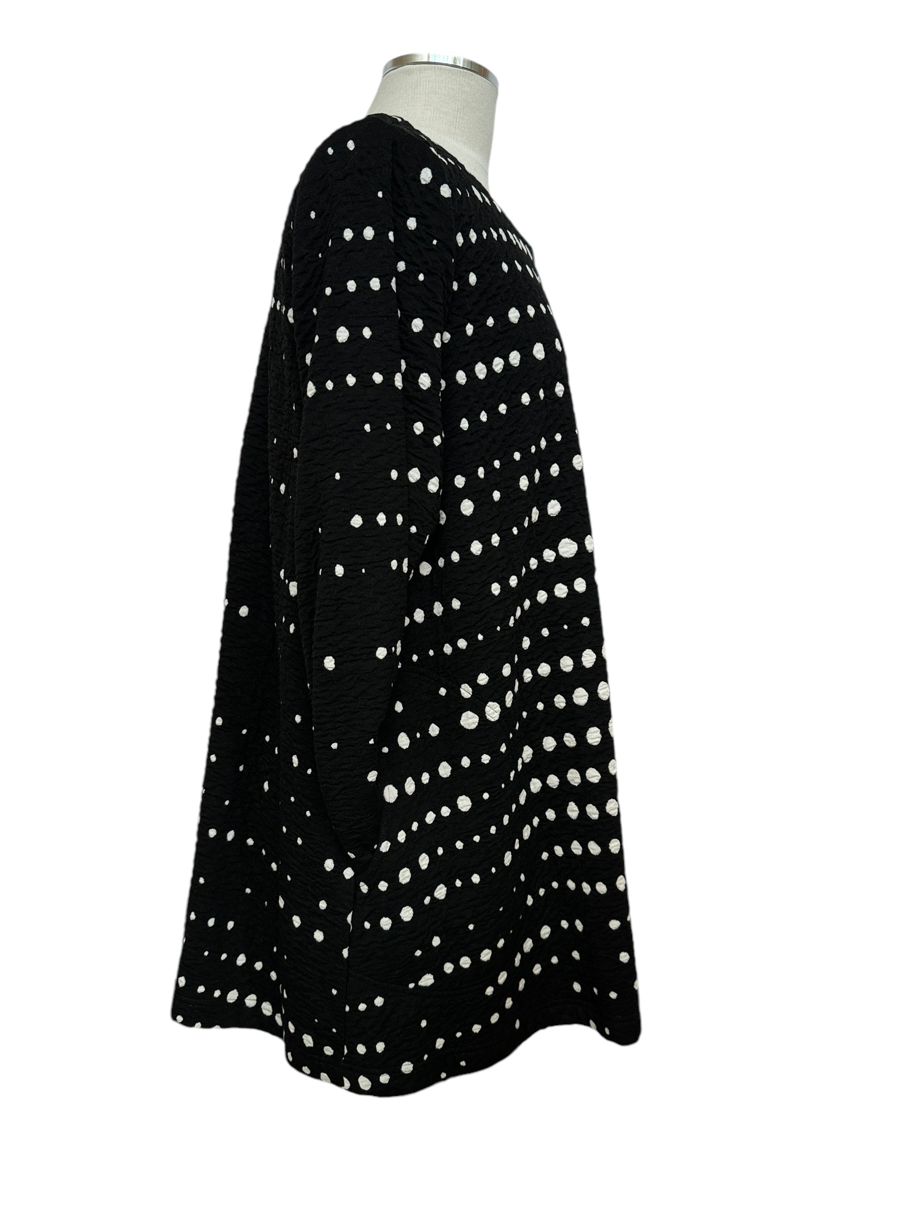 side photo of black & white polka dot knit jacket